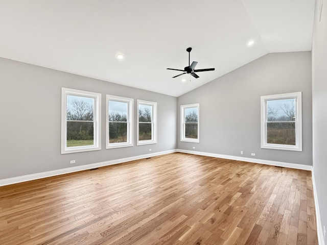 spare room featuring light hardwood / wood-style flooring, vaulted ceiling, and ceiling fan