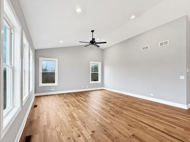 spare room featuring ceiling fan, light hardwood / wood-style flooring, and vaulted ceiling