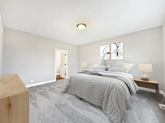 bedroom featuring carpet flooring and connected bathroom