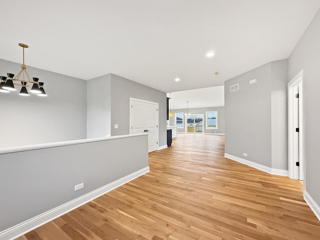 interior space with light hardwood / wood-style floors and a chandelier