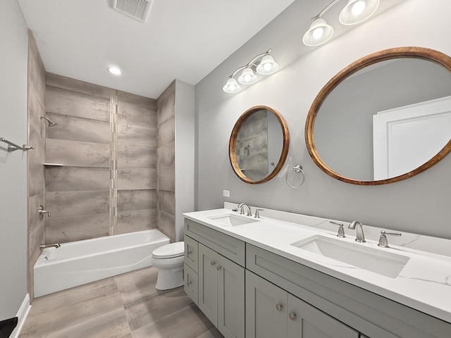 full bathroom featuring vanity, toilet, and tiled shower / bath