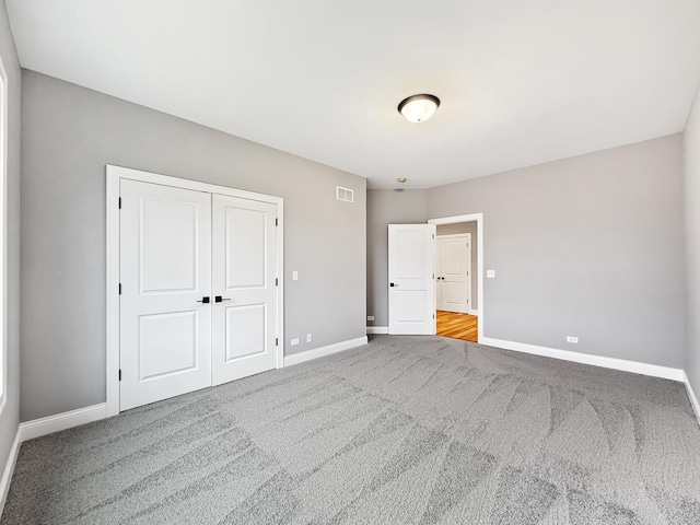 unfurnished bedroom featuring a closet and carpet