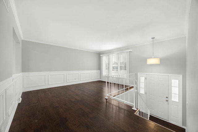 foyer featuring dark wood-type flooring and ornamental molding