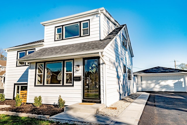 view of front of home featuring a garage and an outdoor structure