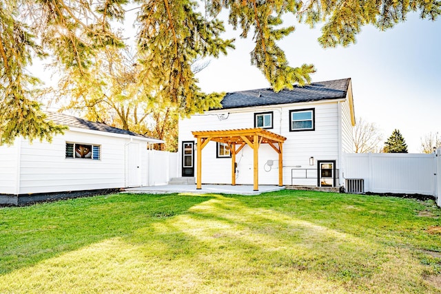 back of house with a pergola, a patio area, and a lawn