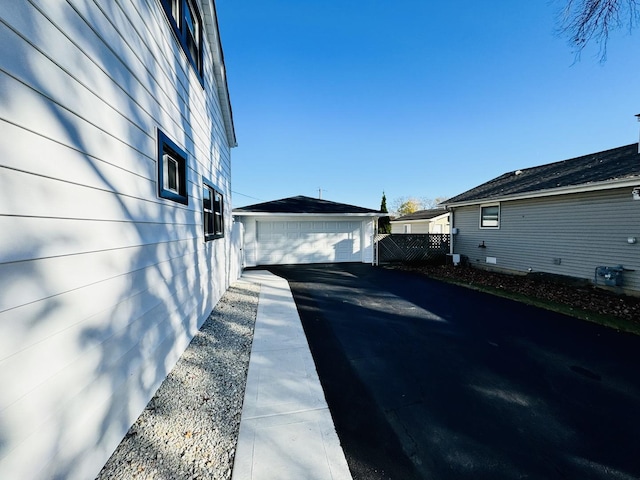 view of side of home featuring an outdoor structure and a garage