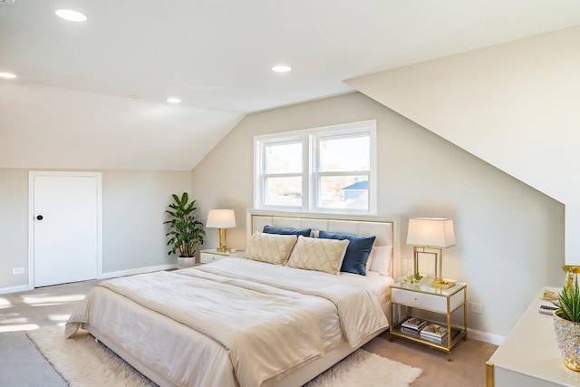 bedroom with carpet floors and vaulted ceiling