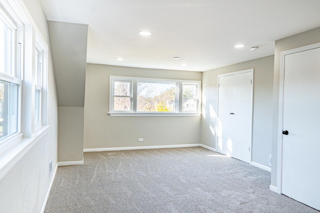 unfurnished bedroom with light colored carpet