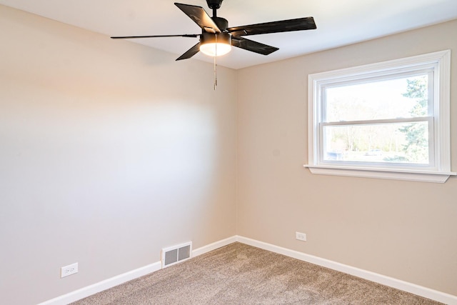 spare room featuring carpet flooring and ceiling fan