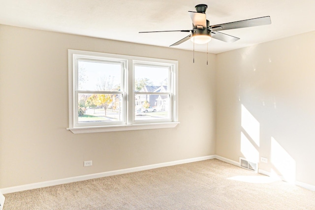 spare room featuring ceiling fan and light colored carpet