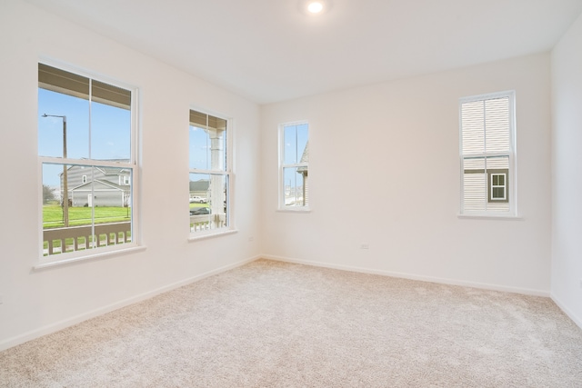 unfurnished room featuring light carpet