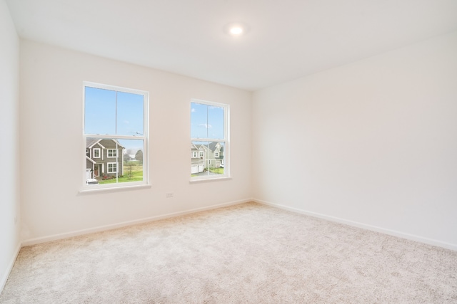 empty room featuring light colored carpet