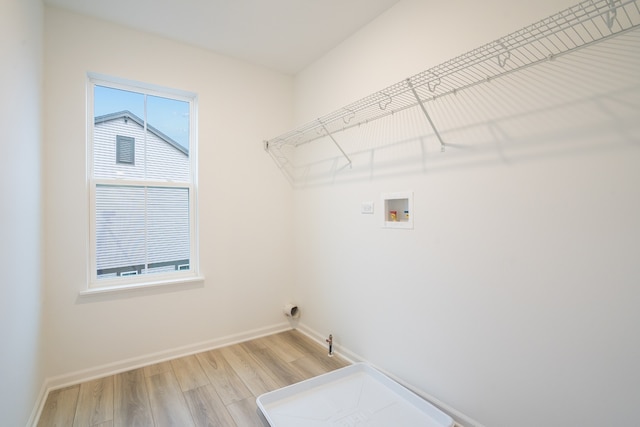 laundry area featuring washer hookup and light hardwood / wood-style floors