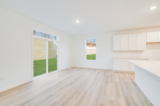 unfurnished dining area with light hardwood / wood-style floors