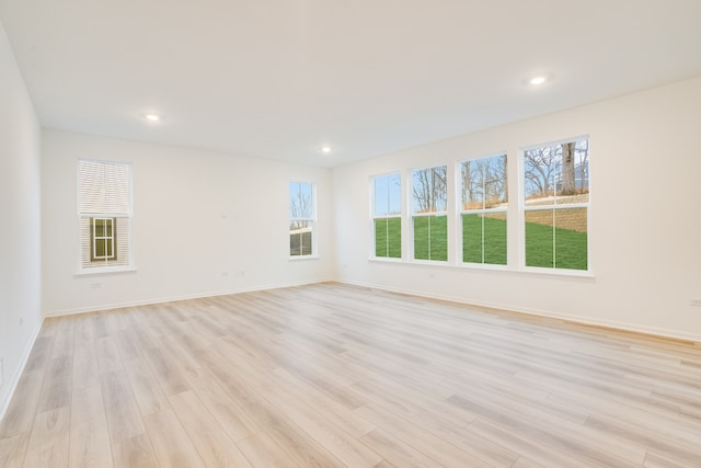 unfurnished room with light wood-type flooring