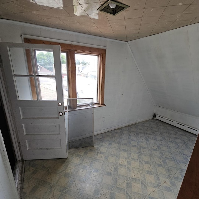 doorway with baseboard heating and a wealth of natural light