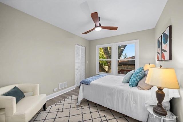 bedroom featuring hardwood / wood-style floors, a closet, and ceiling fan