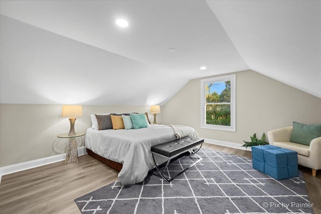 bedroom featuring dark hardwood / wood-style floors and lofted ceiling