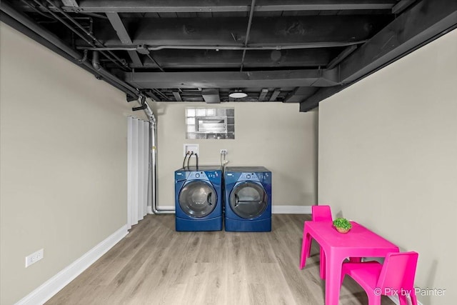 basement featuring hardwood / wood-style floors and independent washer and dryer