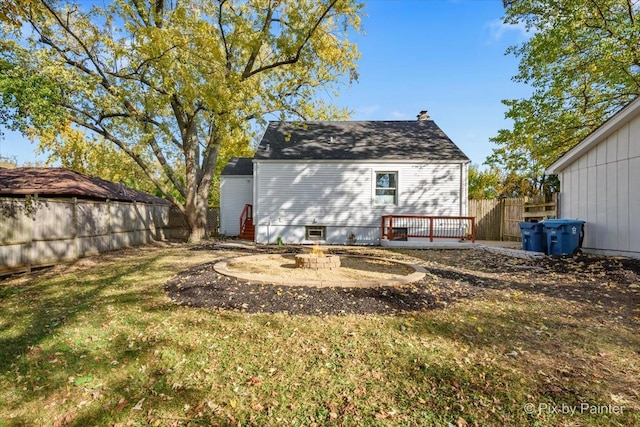 back of house featuring a yard, a fire pit, and a patio area