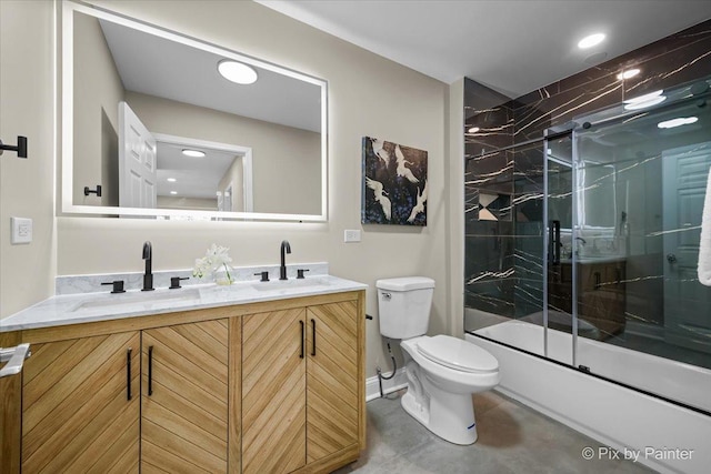 full bathroom featuring vanity, enclosed tub / shower combo, and toilet