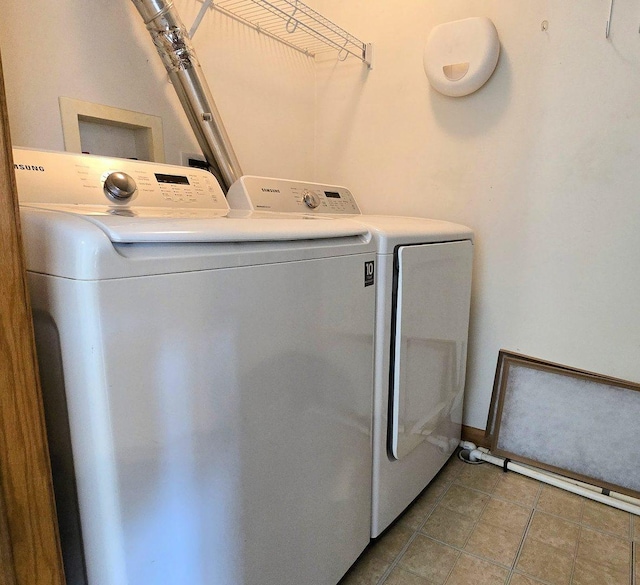 washroom with separate washer and dryer and light tile patterned floors