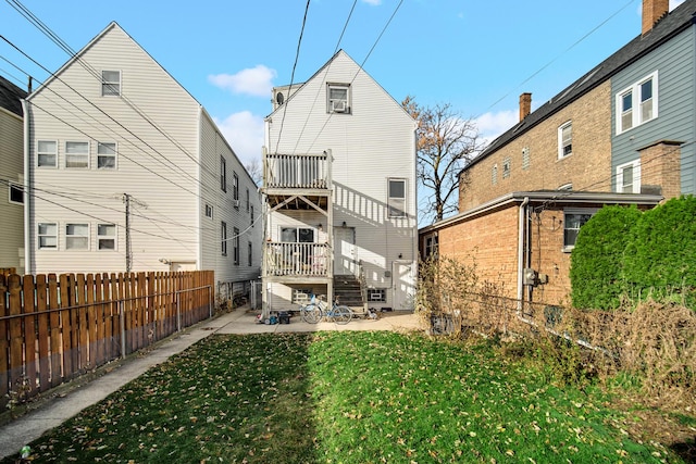 rear view of property featuring a yard