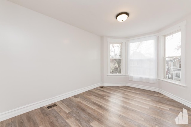 unfurnished room with light hardwood / wood-style floors