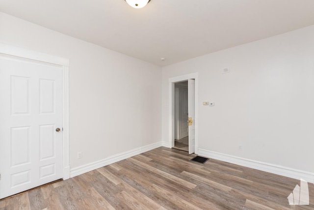 spare room featuring hardwood / wood-style floors