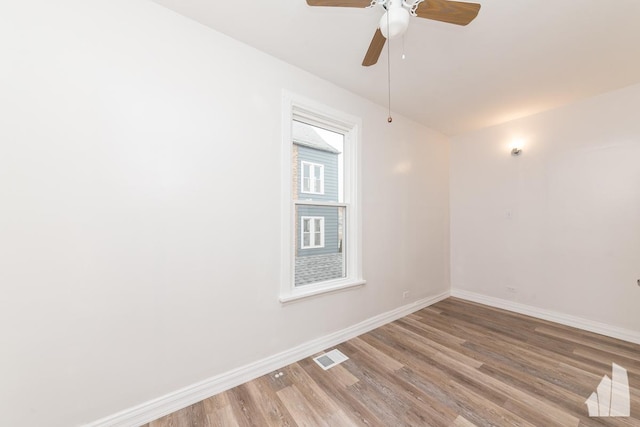 empty room featuring ceiling fan and light hardwood / wood-style floors