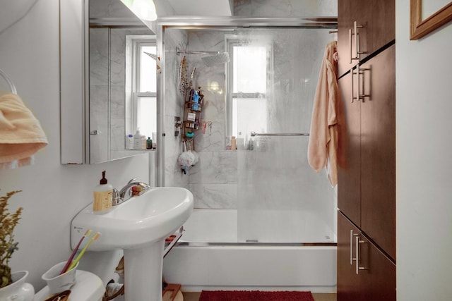 bathroom featuring bath / shower combo with glass door