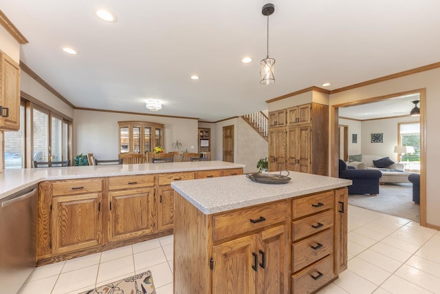 kitchen with a center island, crown molding, hanging light fixtures, stainless steel dishwasher, and a healthy amount of sunlight