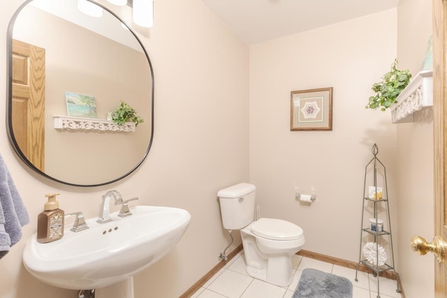 bathroom with tile patterned floors, toilet, and sink