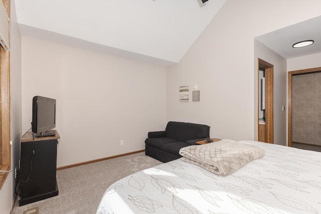 bedroom with light colored carpet and lofted ceiling