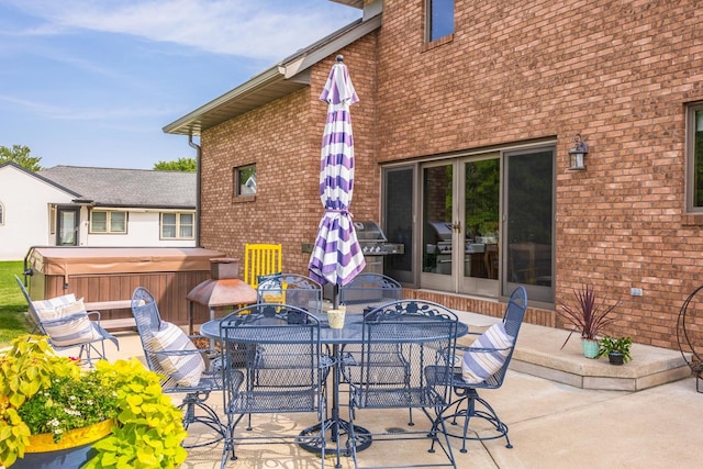 view of patio / terrace with a hot tub