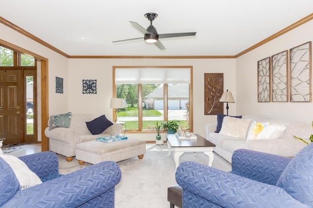 living room featuring ceiling fan, a healthy amount of sunlight, and ornamental molding