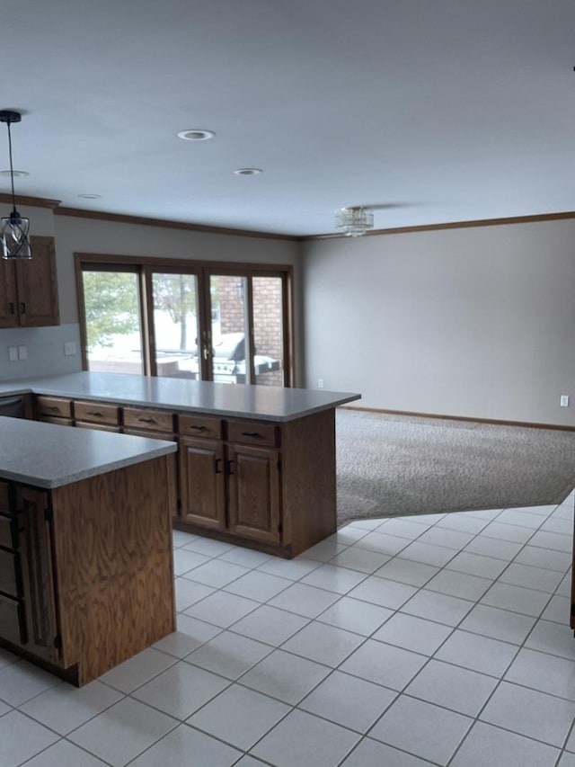 kitchen featuring light tile patterned floors, a center island, and crown molding