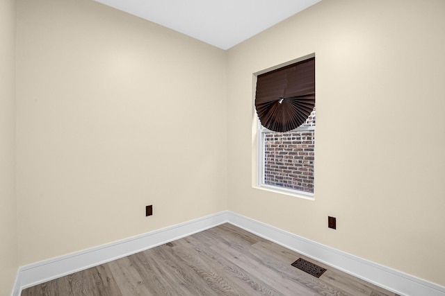 unfurnished room featuring hardwood / wood-style flooring