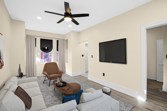 living room featuring hardwood / wood-style floors and ceiling fan