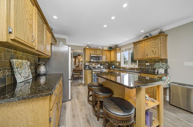 kitchen featuring dark stone counters, light wood-type flooring, ornamental molding, tasteful backsplash, and stainless steel appliances