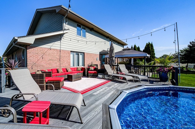 view of pool with outdoor lounge area and a wooden deck