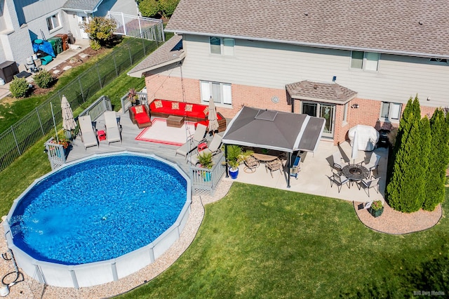 view of pool featuring a lawn, an outdoor living space, and a gazebo