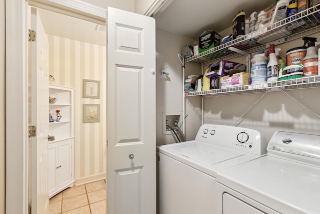 laundry room featuring light tile patterned floors and washing machine and dryer