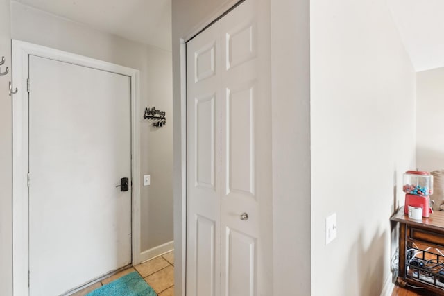 corridor featuring light tile patterned flooring