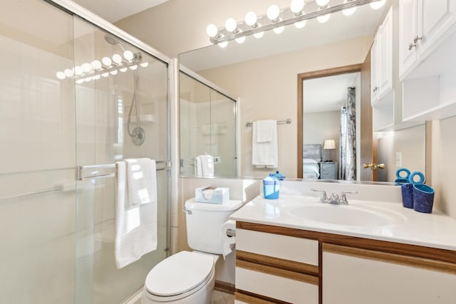 bathroom featuring vanity, toilet, and walk in shower