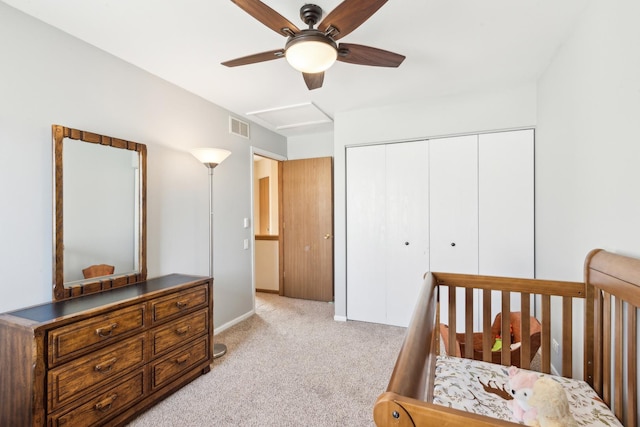 carpeted bedroom featuring ceiling fan and a closet