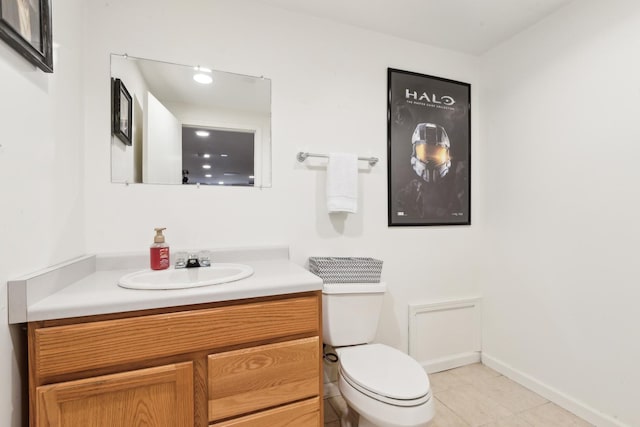 bathroom featuring tile patterned flooring, vanity, and toilet