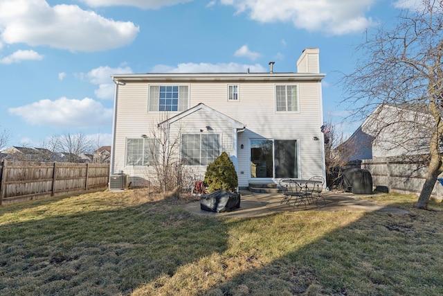 back of house featuring a yard, central AC, and a patio area