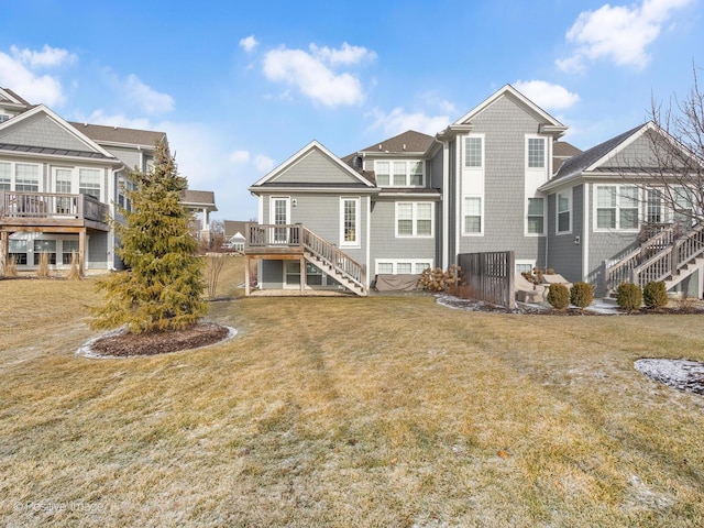 rear view of property with a deck and a lawn