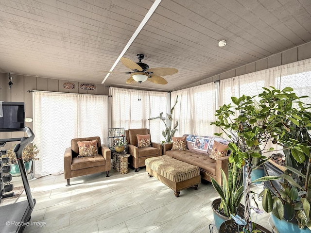 sunroom / solarium with a wealth of natural light and ceiling fan